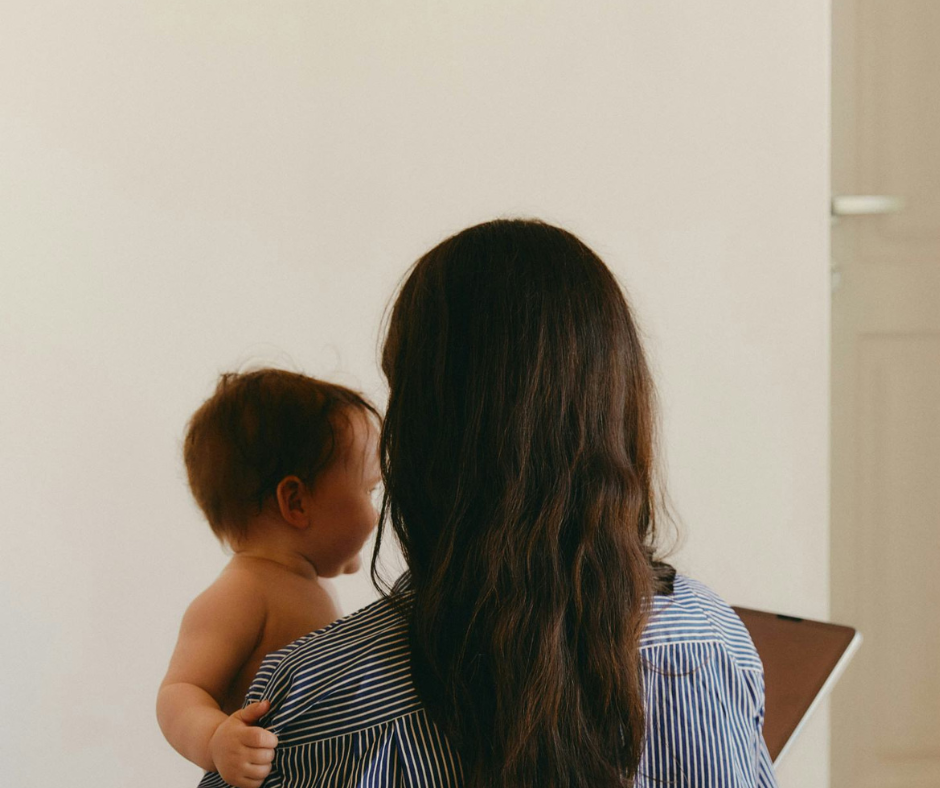 Mother with long hair holding baby