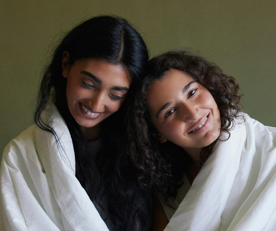 Two women sitting snugly together