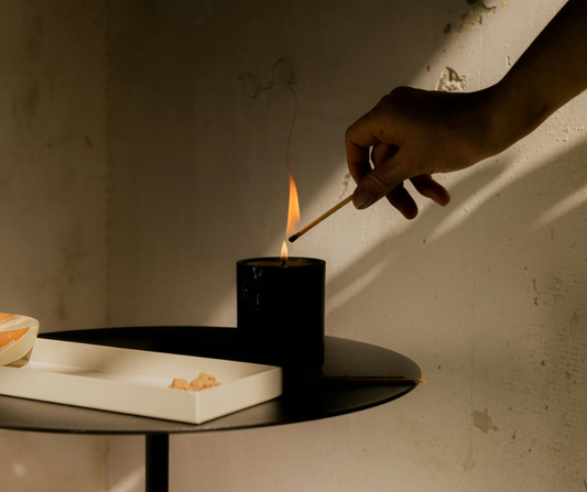 Hand lighting a scented candle